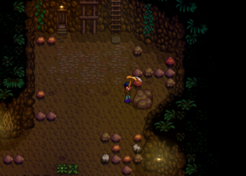 A farmer uses his pickaxe on a boulder in the mines of Stardew Valley